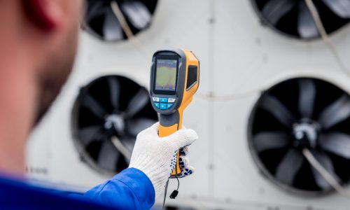 technician-uses-thermal-imaging-infrared-thermometer-check-condensing-unit-heat-exchanger